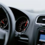 black vehicle dashboard with speedometer on 100
