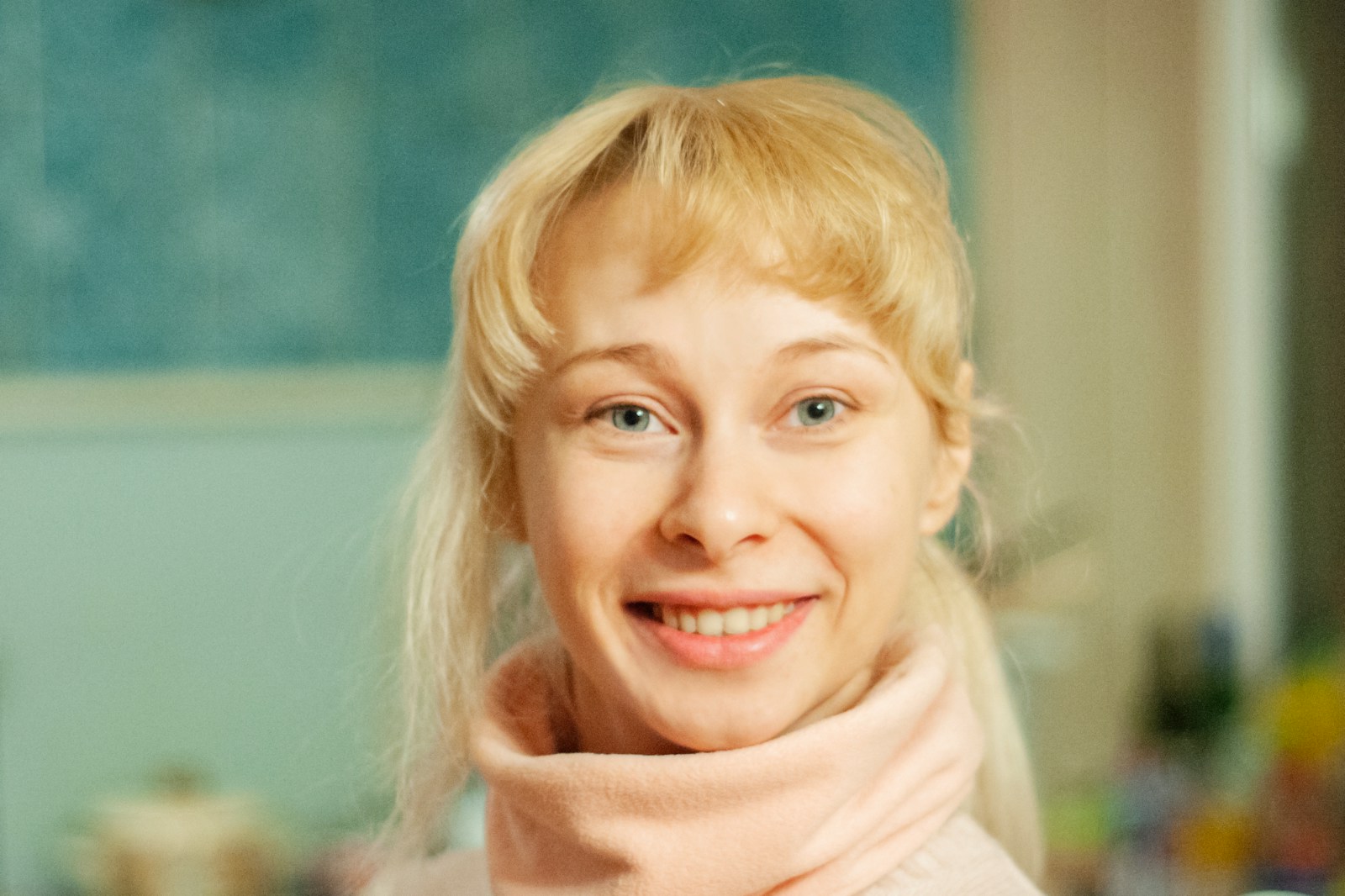 smiling blonde girl wearing white scarf