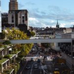 a city street filled with lots of traffic next to tall buildings
