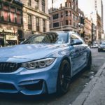 blue BMW coupe parked on the road during daytime