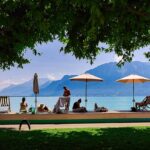 A group of people sitting under umbrellas on a beach