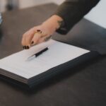 a person writing on a piece of paper