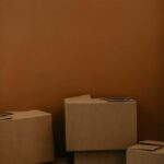 A stack of brown cardboard boxes against a solid brown background